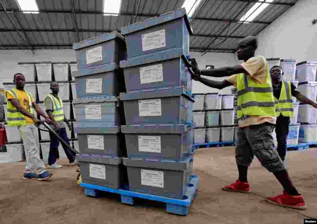 Election workers move boxes of voting materials at the National Electoral Commission headquarters in Monrovia, Oct. 9, 2017.