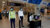 FILE - A health worker monitors a screen showing a thermal scan to check the temperatures of passengers at the Kotoka International Airport in Accra, Ghana Jan. 30, 2020.