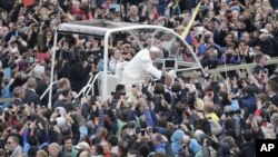 FILE - Pope Francis salutes faithful gathered in St. Peter's Square at the Vatican, April 5, 2015. 