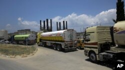 Egyptian trucks carrying fuel enter Gaza's power plant in the central Gaza Strip, June 21, 2017. Egypt on Wednesday trucked 1 million liters of cheap diesel to the Gaza Strip's sole power plant — a rare shipment that temporarily eased a crippling electric
