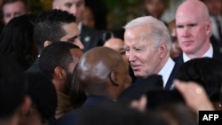 US President Joe Biden greets attendees during a reception in recognition of Black History in the East Room of the White House on Feb. 6, 2024. 