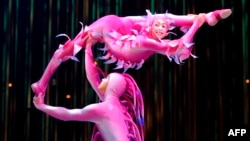 FILE - Cirque du Soleil performs onstage in Mexico City, Sept. 18, 2013. Cirque co-founder Gilles Ste-Croix has helped children in Mexico learn the tricks of the trade through the Circo de los Ninos school.