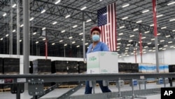 Boxes containing the Moderna COVID-19 vaccine are prepared to be shipped at the McKesson distribution center in Olive Branch, Miss., Dec. 20, 2020. 