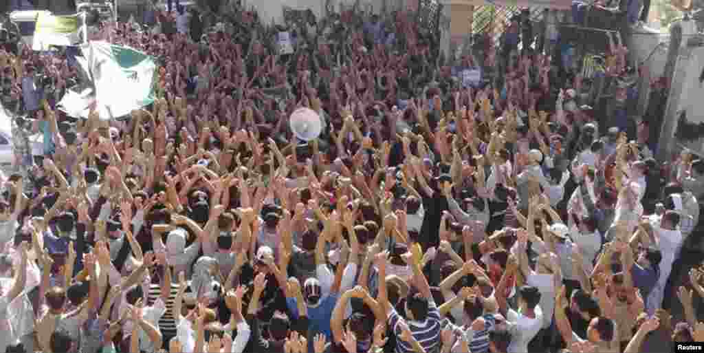 Residents gather during the funeral of Hussein Omish, whom protesters say was killed by forces loyal to Syria's President Bashar al-Assad, in Jubar outside Damascus, Syria, June 18, 2012.