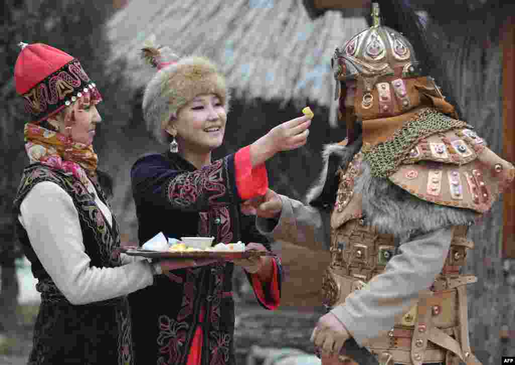 Wearing their traditional costumes Kyrgyz women and a man take part in the celebrations of Nowruz (New Year) in the outskirts of the Kyrgyzstan&#39;s capital Bishkek. Nowruz, &quot;The New Year&quot; in Farsi, is an ancient festival marking the first day of spring in Central Asia.