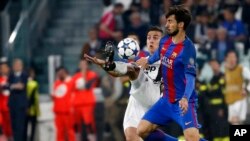 Paulo Dybala de Juventus, à gauche, dans un duel avec André Gomes de Barcelone lors du match Juventus-Barcelone en quart de finale de la Ligue des champions au stade de Turin, Italie, 11 avril 2017.