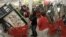 File — Early bird shoppers snatch up flat screen televisions at the Target store in Mayfield Hts., Ohio, on Black Friday.