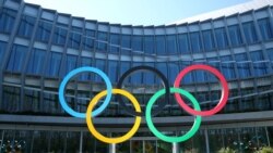 FILE -: The Olympic rings in front of the International Olympic Committee in Lausanne, Switzerland, March 24, 2020.