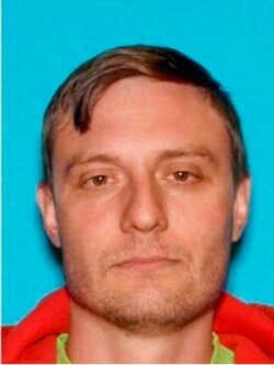 FILE - This undated Department of Motor Vehicles photo provided by the FBI shows Robert Alvin Justus Jr., who has been charged with aiding and abetting the murder and attempted murder of two Federal Protective Services security officers.
