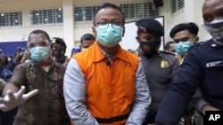 Menteri Kelautan dan Perikanan Edhy Prabowo (tengah) dikawal petugas keamanan usai menjalani konferensi pers di Komisi Pemberantasan Korupsi (KPK) di Jakarta, pada 26 November 2020. (Foto: AP)