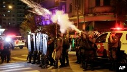 Police fire tear gas against supporters of Brazil's suspended President Dilma Rousseff during a rally in Sao Paulo, Brazil, Tuesday, Aug. 30, 2016.