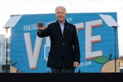 President-elect Joe Biden waves from the stage as he campaigns for for Georgia Democratic candidates for U.S. Senate, Rev. Raphael Warnock and Jon Ossoff in Atlanta, Jan. 4, 2021.