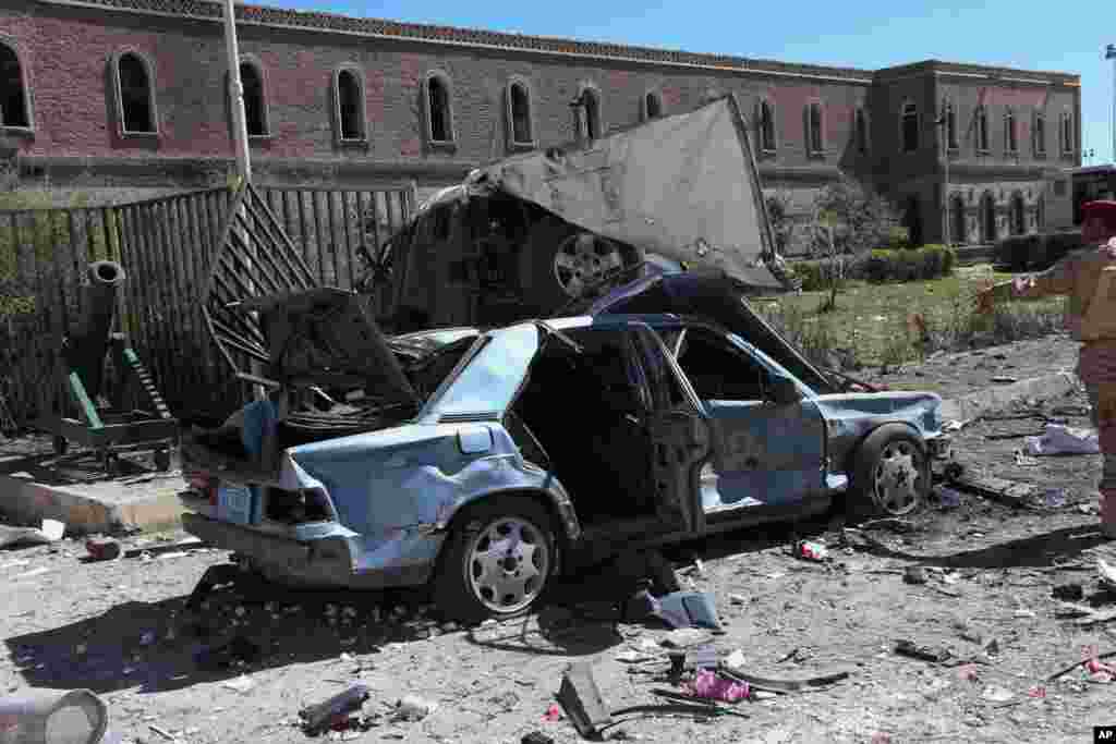 This photo provided by Yemen's Defense Ministry shows damaged vehicles after an explosion at the Defense Ministry complex in Sana'a, Dec. 5, 2013.