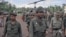 Lt. General Lon Nol, the Cambodian Prime Minister (foreground three stars) is followed by his high-command at the end of a visit they made to Skuon the task force headquarters in Cambodia on Sept. 23, 1973. The group made the fight to and from Phnom Penh via helicopters. (AP Photo/Max Nash)