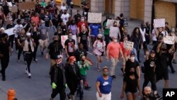 Demonstrators protest over the deaths of George Floyd and Breonna Taylor, June 1, 2020, in Louisville, Ky. Breonna Taylor, a black woman, was fatally shot by police in her home in March.