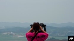A visitor views the North Korea side from the Unification Observation Post in Paju South Korea, near the border with North Korea, Thursday, June 17, 2021. The North Korea's official Korean Central News Agency said Wednesday, June 16, 2021, that…