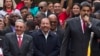 FILE - Cuba's President Raul Castro, left, and Nicaragua's President Daniel Ortega, second left, listen to a speech by Venezuela's President Nicolas Maduro, outside of Miraflores palace during a rally in Caracas, Venezuela, March 5, 2018. 