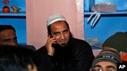 FILE - Kashmiri separatist leader Masarat Alam speaks on a phone at his home in Srinagar, India.