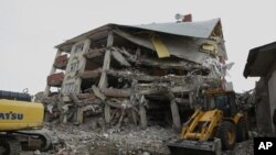 Firefighters from Istanbul and soldiers search for Tahir Ormanoglu, a teacher, 27, believed to be trapped beneath, as hopes of finding more survivors were dimming in Ercis, Van Turkey, October 29, 2011.