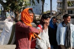 Daily wage laborers leave for their respective villages as the city comes under lockdown in Prayagraj, India, March 26, 2020.