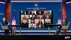 US President-elect Joe Biden(L) and US Vice President-elect Kamala Harris speak virtually with the Covid-19 Advisory Council during a briefing at The Queen theatre on November 9, 2020 in Wilmington, Delaware. (Photo by Angela Weiss / AFP)