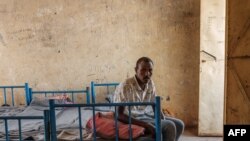 FILE - Kheder Adam, an Eritrean refugee who fled Ethiopia's Tigray conflict, rests on his bed at the Border Reception Centre in Hamdayit, eastern Sudan, Dec. 8, 2020. 