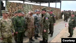 Military members salute a Russian general during joint military exercises of the Shanghai Cooperation Organization (SCO) in Russia's Orenburg region, in an image from video released by Pakistan Army’s media wing ISPR.
