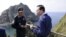 South Korean President Lee Myung-bak, right, talks with police officer Yoon Jang-soo as Lee visits islands called Dokdo in Korea and Takeshima in Japan, Aug. 10, 2012.