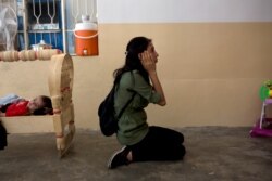 FILE - Layla Taloo reacts as she visits a room in the house where she was held along with her husband and children after Islamic State militants captured the family in 2014, in Tal Afar, Iraq, Aug. 31, 2019.