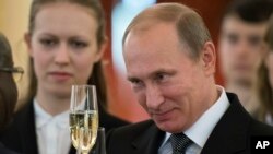 FILE - Russian President Vladimir Putin toasts with ambassadors after a ceremony of presentation of credentials by foreign ambassadors in the Grand Kremlin Palace in Moscow.