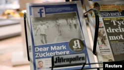 The front page of Norway's Aftenposten is seen at a news stand in Oslo, Norway, Sept. 9, 2016. The newspaper's chief editor accused Facebook of abusing its power after it deleted an 1972 iconic image of a nude Vietnamese girl running from a napalm attack.