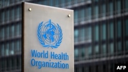 (FILES) This photograph taken on December 7, 2021 shows a sign of the World Health Organisation (WHO) at their headquarters in Geneva.