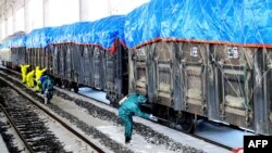 This undated picture released from North Korea's official Korean Central News Agency on March 4, 2020 shows workers disinfecting freight trains to prevent the spread of the COVID-19 coronavirus in Sinuiju, North Pyongan Province.