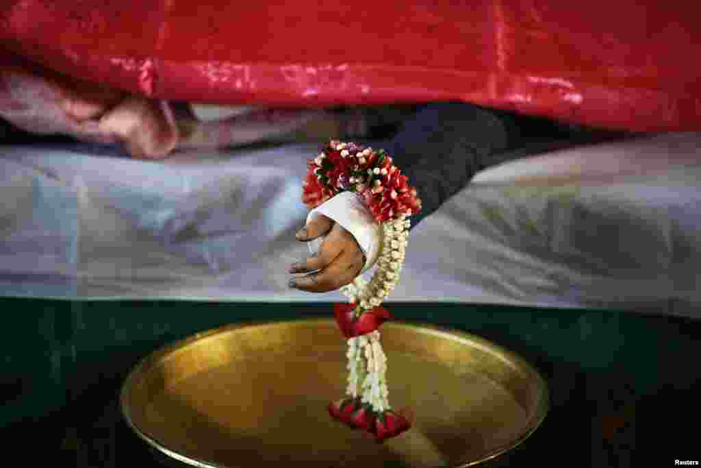 The body of one of the siblings killed in a bomb blast near an anti-government protest site on Feb. 23 is prepared for a funeral at a Buddhist temple, Bangkok, Feb. 24, 2014.&nbsp;