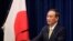 FILE - Japanese Prime Minister Yoshihide Suga speaks at a news conference in Tokyo, Dec. 4, 2020. 