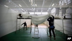 Volonteri i vojska pripremaju halu na sajmu u Bergamu za smještaj pacijenata.