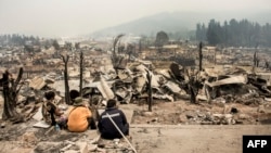 View of the remains of Santa Olga, 350 kilometers south of Santiago, after being devastated by a forest fire, Jan. 27, 2017. 