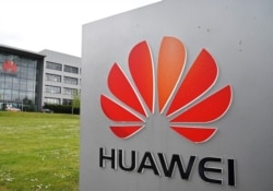 FILE - Signage is seen at the Huawei offices in Reading, Britain, May 2, 2019.