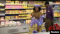 FILE - A Herero woman shops at a Shoprite store in Otjinene Village in the Omaheke Region, Namibia, Feb. 22, 2017. 