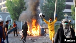Iraqi demonstrators clash with security forces during anti-government protests in Baghdad, Nov. 9, 2019.