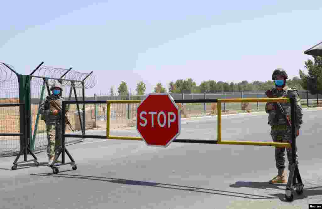 Border guards are seen at a checkpoint at the Uzbekistan-Afghanistan border in Ayritom, Uzbekistan, Aug. 15, 2021.