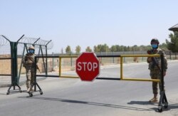 FILE - Border guards are seen at a checkpoint at the Uzbekistan-Afghanistan border in Ayritom, Uzbekistan, Aug. 15, 2021.