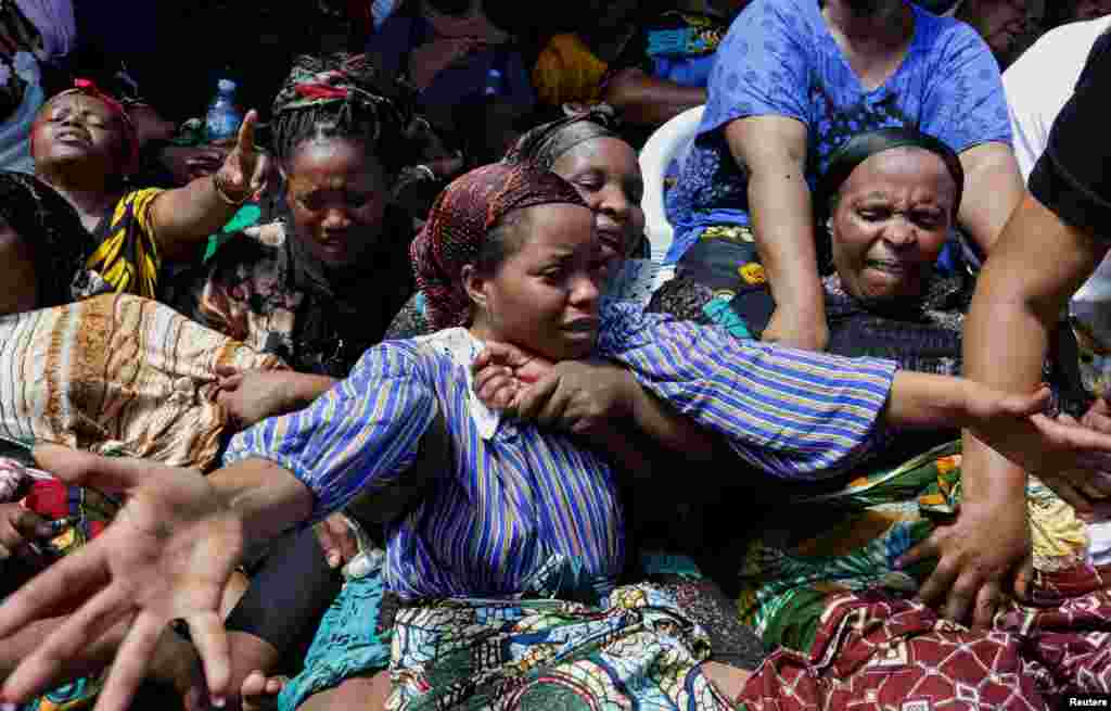 Relatives mourn at a farewell ceremony to remember the residents killed after a four-story building collapsed over the weekend at the Kariakoo suburb, in Dar es Salaam, Tanzania.