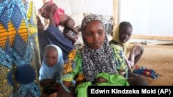 A family of refugees that fled their homes due to violence from the Islamic extremist group Boko Haram sit inside a refugee camp in Minawao, Cameroon on Feb. 25, 2015