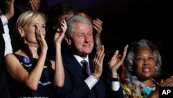 Former President Bill Clinton applauds Former Democratic Presidential candidate, Sen. Bernie Sanders, I-Vt., as he speaks during the first day of the Democratic National Convention in Philadelphia , Monday, July 25, 2016.