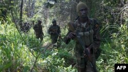 FILE - Soldiers of the Uganda People's Defense Force (UPDF) patrol in the jungle in the Central African Republic as they look for Lord's Resistance Army (LRA) fighters.