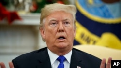 In this Dec. 11, 2018 photo, President Donald Trump speaks during a meets with Democratic leaders the Oval Office in Washington. 