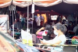COVID-19 patients are seen in an emergency tent put up outside of RSUD Bekasi Hospital, in Bekasi City, West Java, June 30, 2021. The surge in new daily cases has overwhelmed the hospital itself. (Indra Yoga/VOA Indonesian)