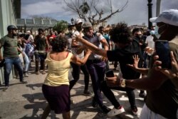 FILE - Police scuffle with anti-government demonstrators during a protest in Havana, Cuba, July 11, 2021.