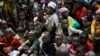 FILE - Refugees who fled Burundi's violence and political tension wait to board a ship freighted by the United Nations, at Kagunga on Lake Tanganyika, Tanzania, May 23, 2015.